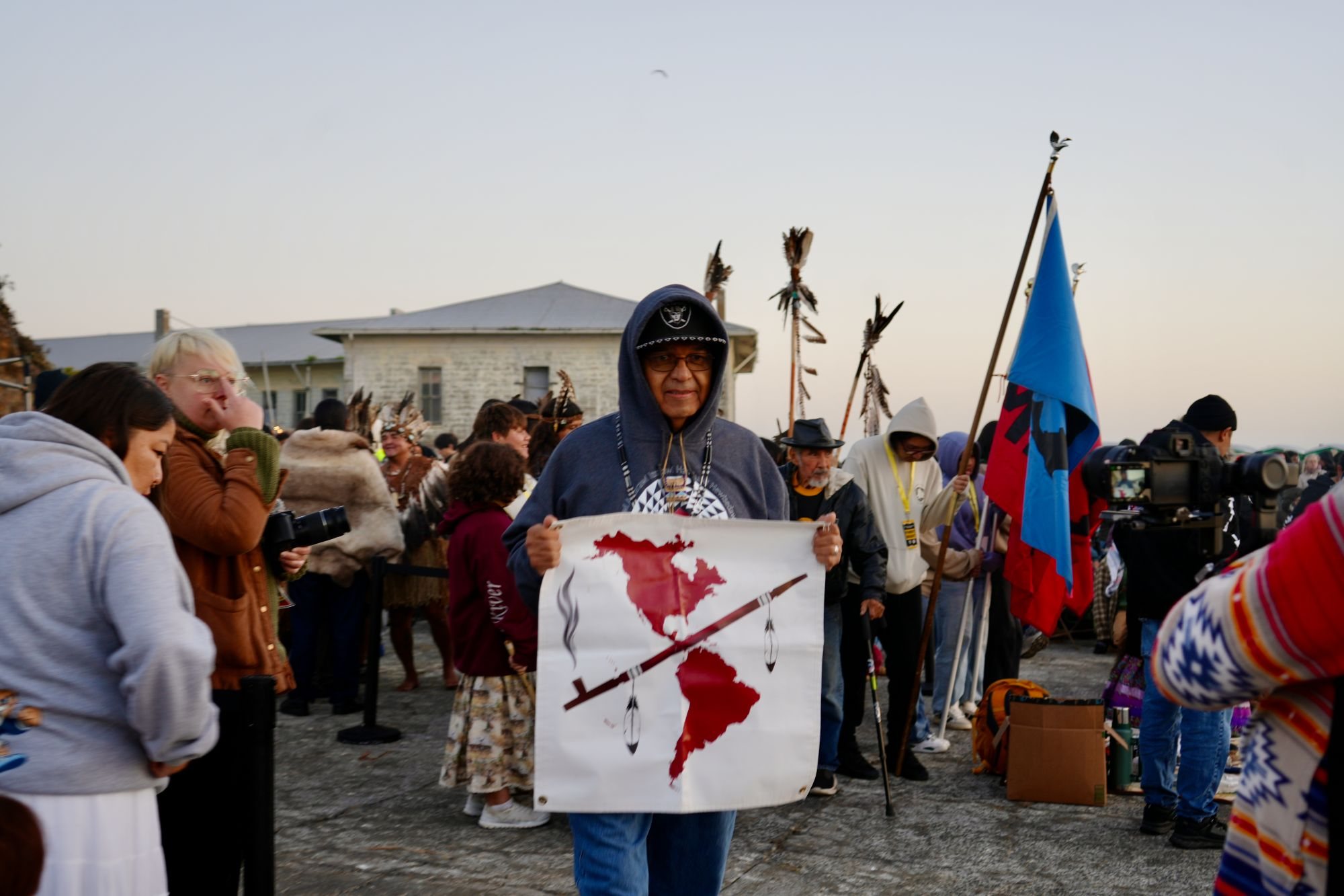 Participants at the Indigenous Peoples' Day Sunrise Gathering on Alcatraz Island at dawn.