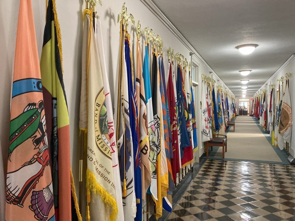 Tribal flags line a hallway at the U.S. Department of the Interior in Washington.