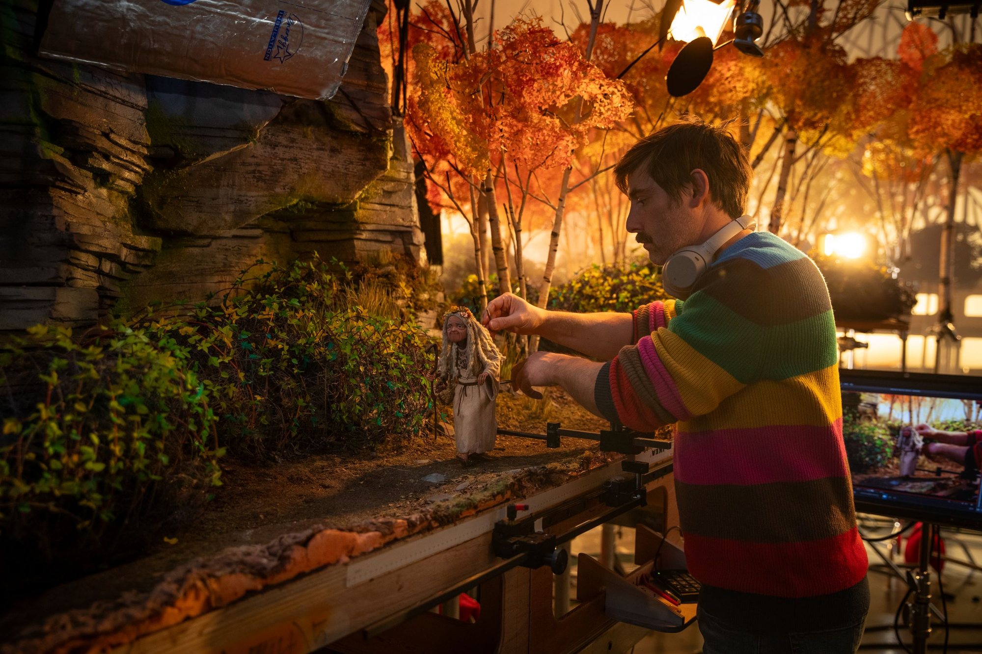 A LAIKA crew member positions the Iphigenia puppet on a Wildwood set.